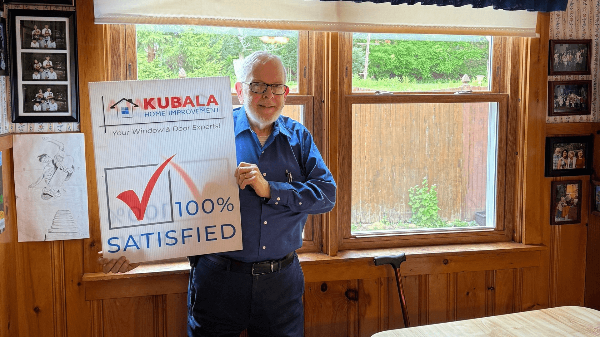 Picture of homeowner smiling and holding a "100% Satisfied" sign in front of his new windows in Warren, MA.